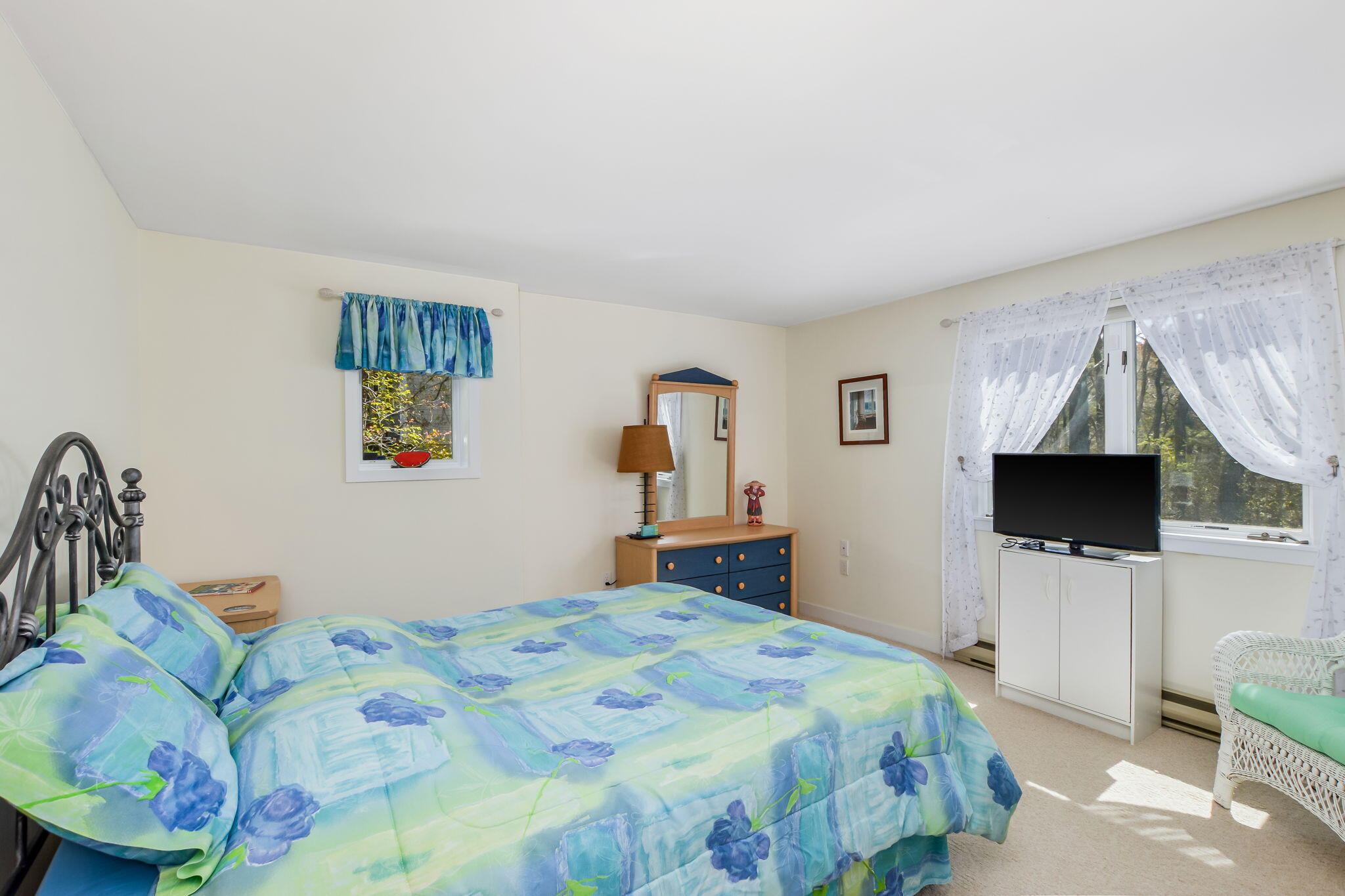 240 Surf Drive Mashpee, MA 02649 - Photo 21 of 37 a bedroom with a bed and a flat screen tv