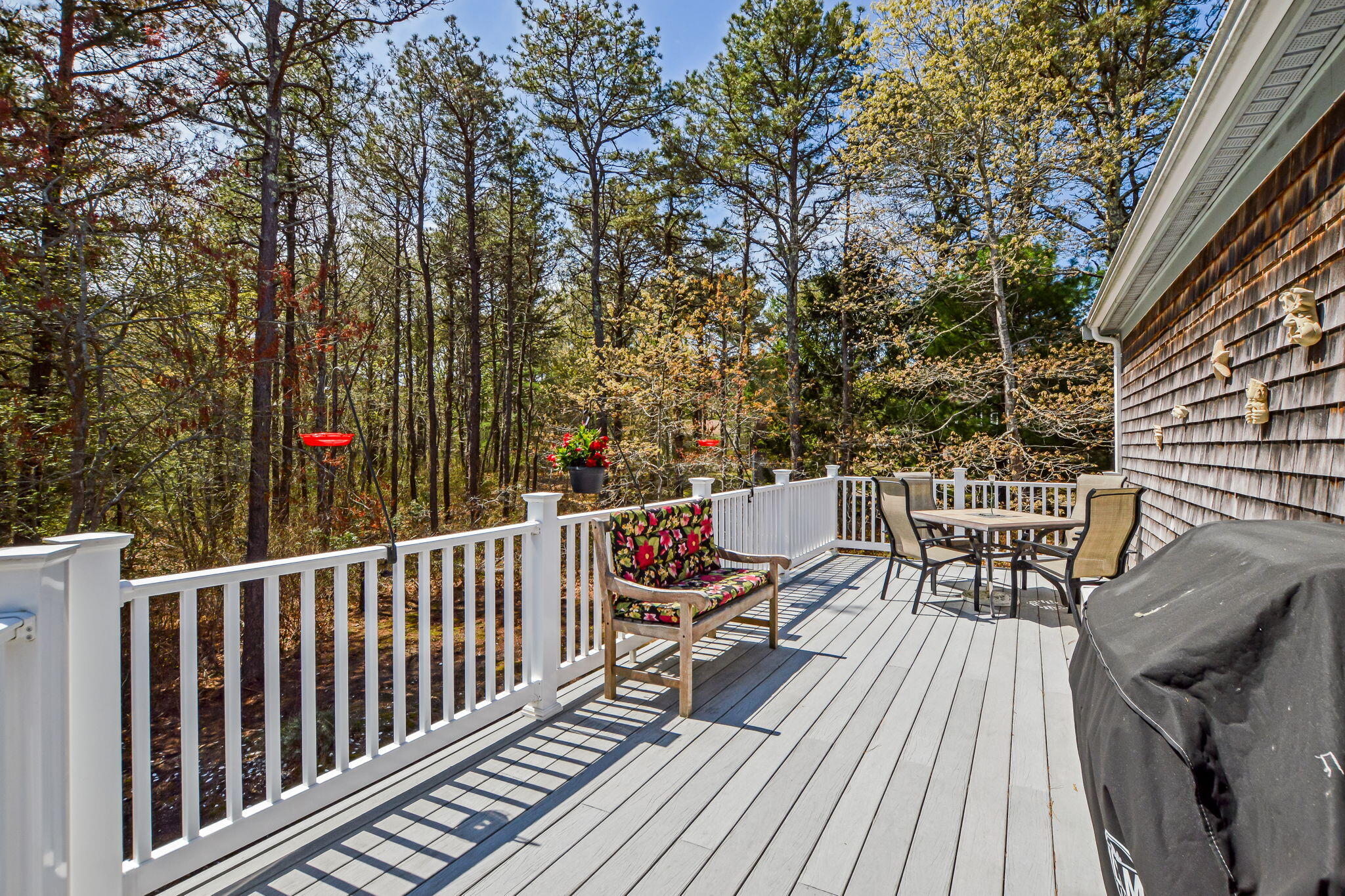 240 Surf Drive Mashpee, MA 02649 - Photo 27 of 37 a balcony with wooden floor and outdoor seating