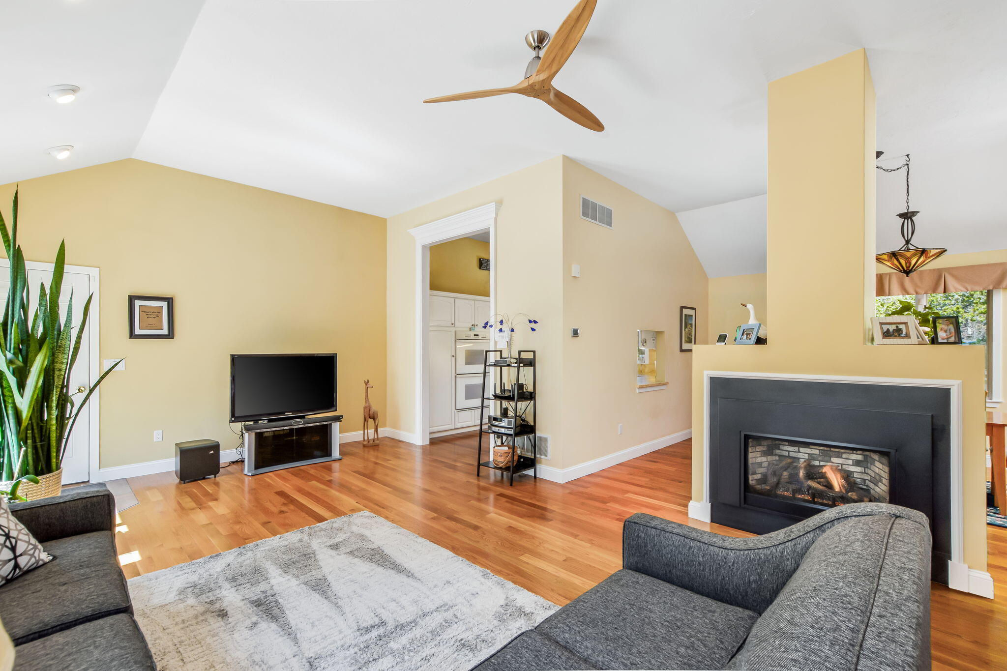 240 Surf Drive Mashpee, MA 02649 - Photo 8 of 37 a living room with furniture a fireplace and a flat screen tv