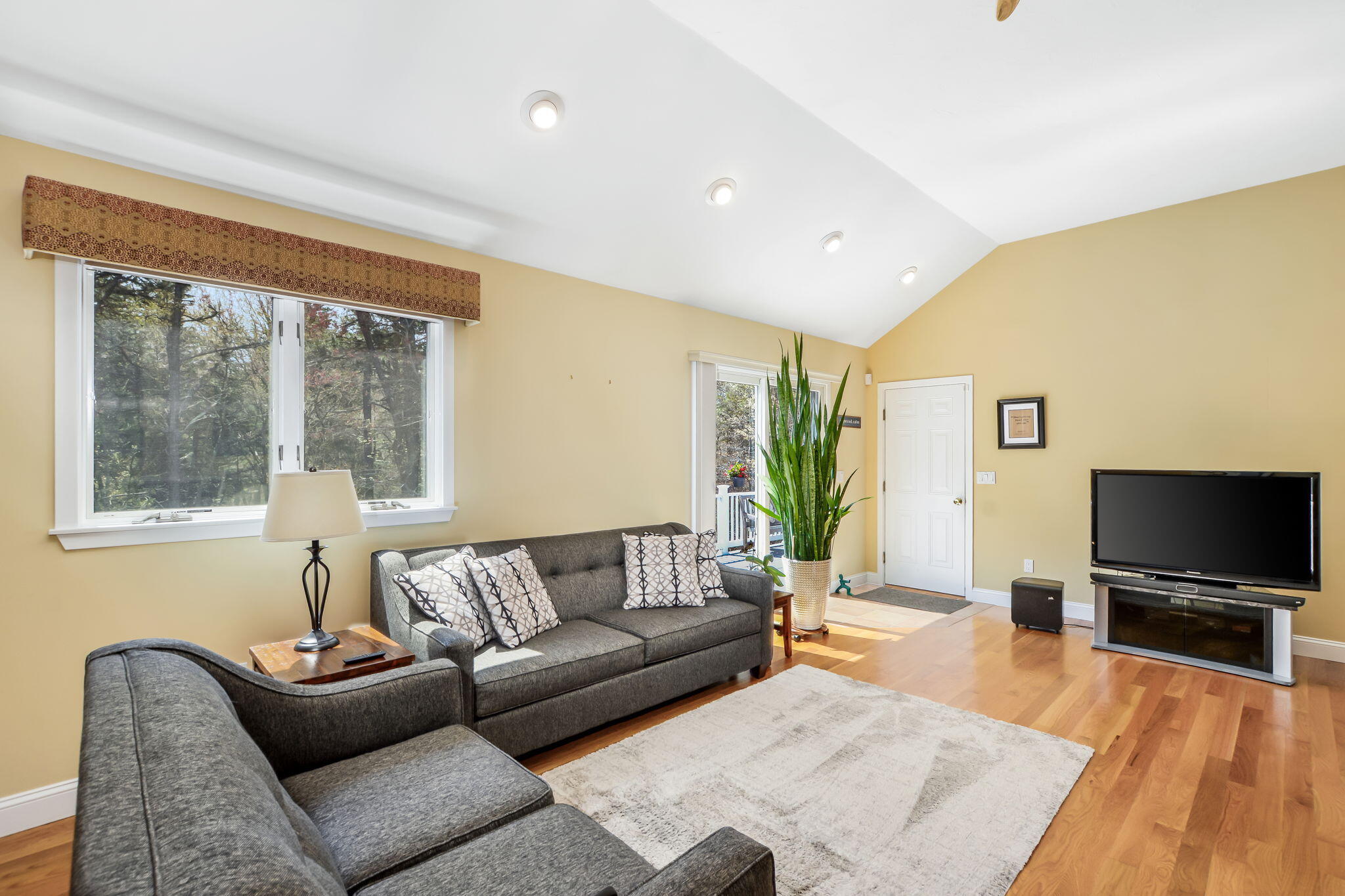 240 Surf Drive Mashpee, MA 02649 - Photo 9 of 37 a living room with furniture and a flat screen tv