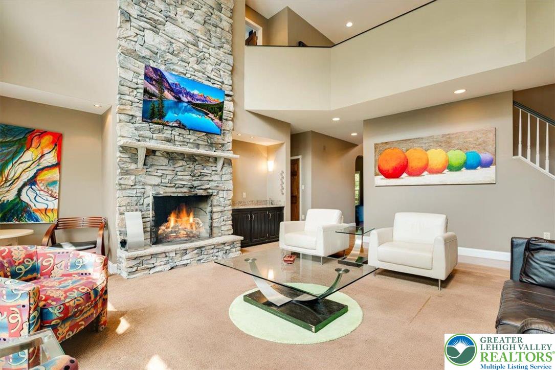 1488 Kelly Road Stroudsburg, PA 18360 - Photo 13 of 89 a living room with furniture a flat screen tv and a fireplace