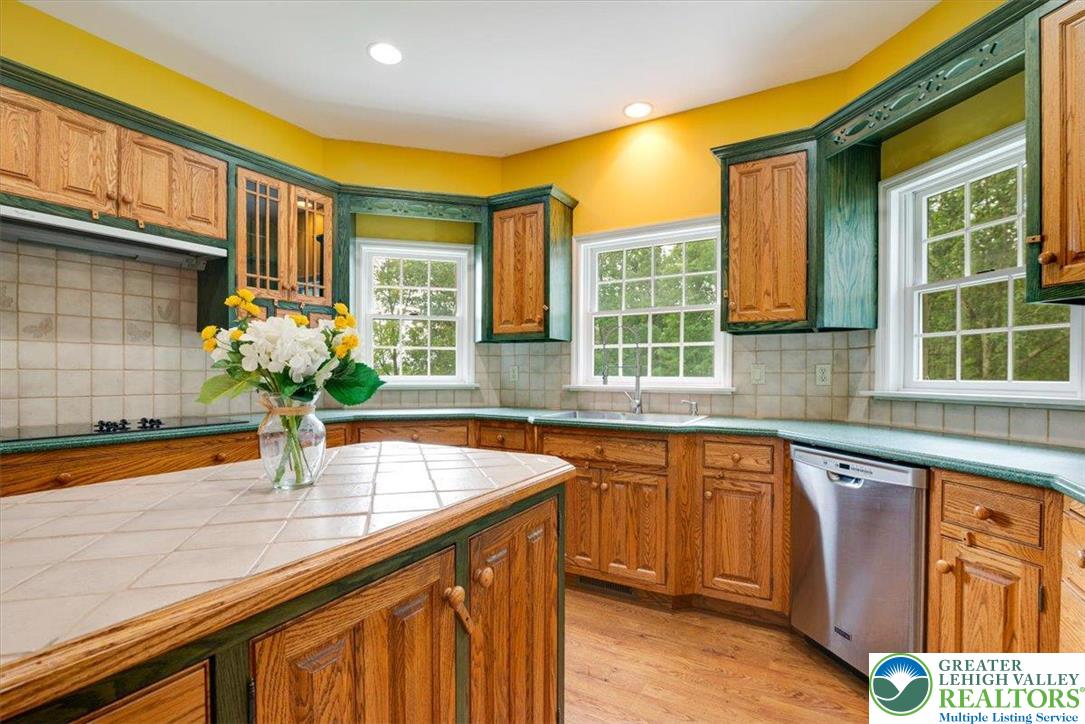 1488 Kelly Road Stroudsburg, PA 18360 - Photo 21 of 89 a kitchen with stainless steel appliances granite countertop a sink and wooden cabinets