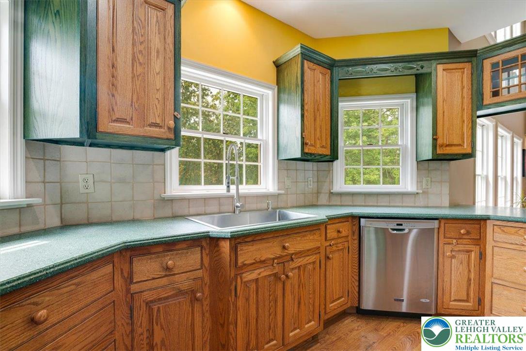 1488 Kelly Road Stroudsburg, PA 18360 - Photo 22 of 89 a kitchen with granite countertop wooden cabinets a sink and a window