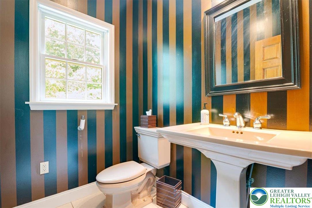 1488 Kelly Road Stroudsburg, PA 18360 - Photo 36 of 89 a bathroom with a sink a toilet and mirror