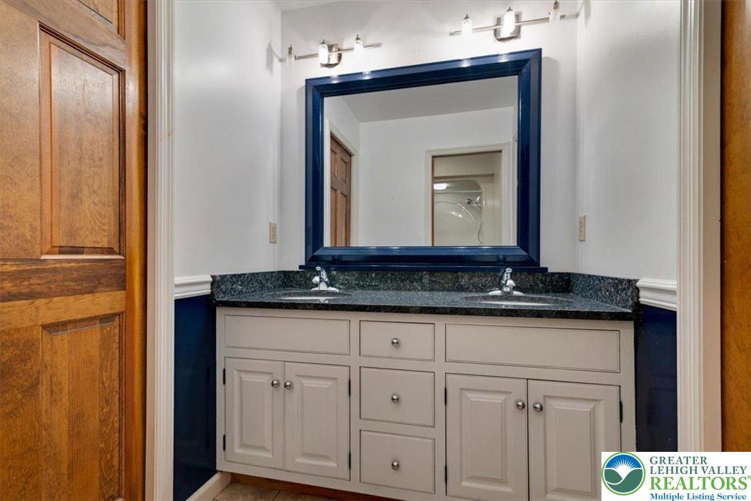 1488 Kelly Road Stroudsburg, PA 18360 - Photo 46 of 89 a bathroom with a granite countertop sink and a mirror