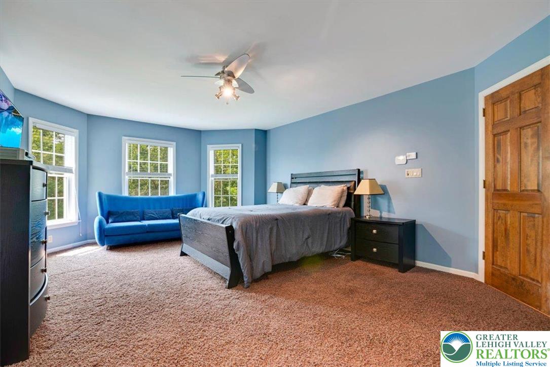 1488 Kelly Road Stroudsburg, PA 18360 - Photo 51 of 89 a bedroom with a bed and wooden floor