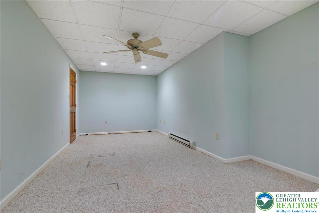 1488 Kelly Road Stroudsburg, PA 18360 - Photo 67 of 89 an empty room with a ceiling fan and carpet