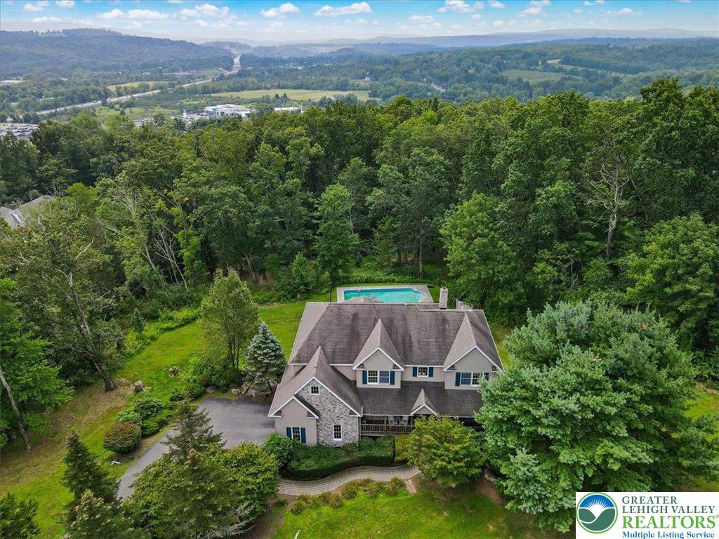 1488 Kelly Road Stroudsburg, PA 18360 - Photo 87 of 89 an aerial view of a house with yard and outdoor seating