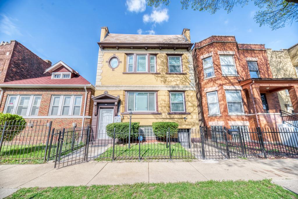 6840 South Prairie Avenue Chicago, IL 60637 - Photo 1 of 47 a front view of a house with a yard