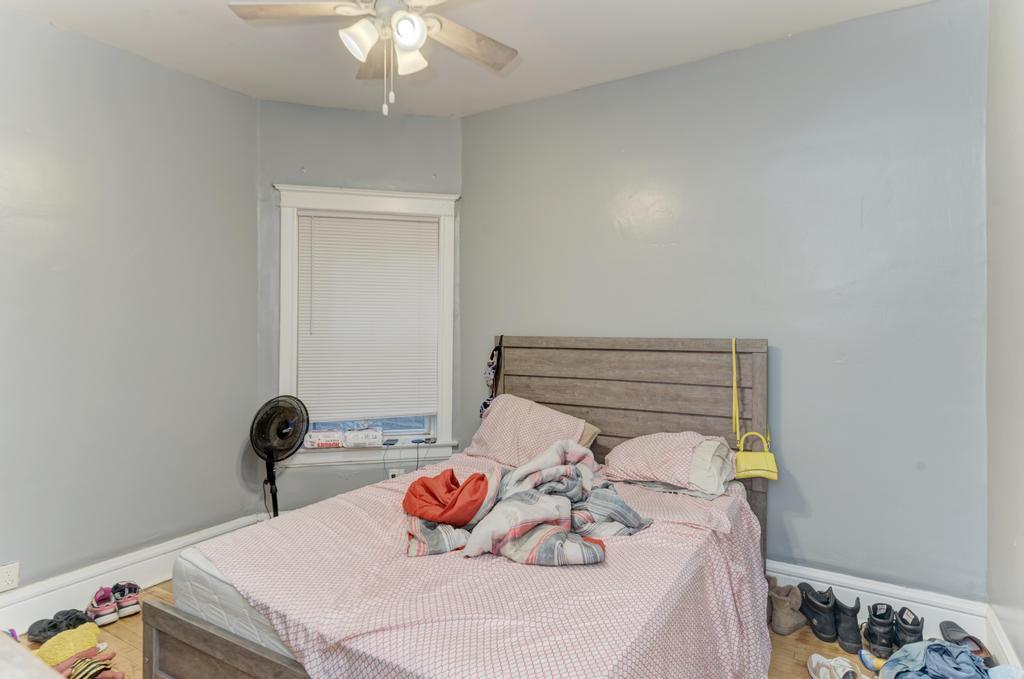 6840 South Prairie Avenue Chicago, IL 60637 - Photo 11 of 47 a bedroom with a bed and wooden floor