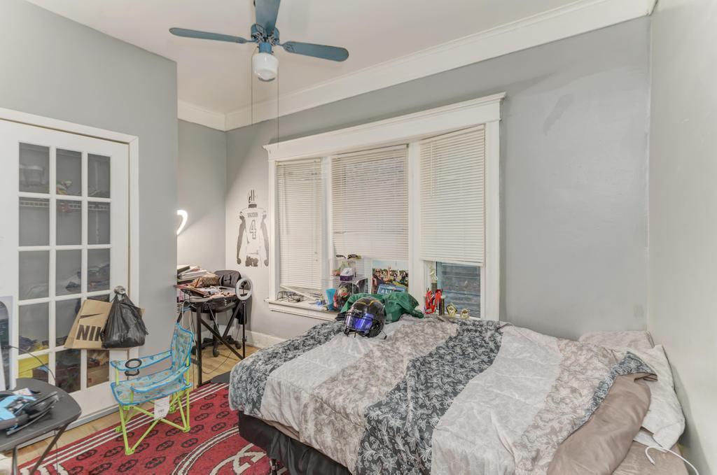 6840 South Prairie Avenue Chicago, IL 60637 - Photo 12 of 47 a bed room with a bed and a table