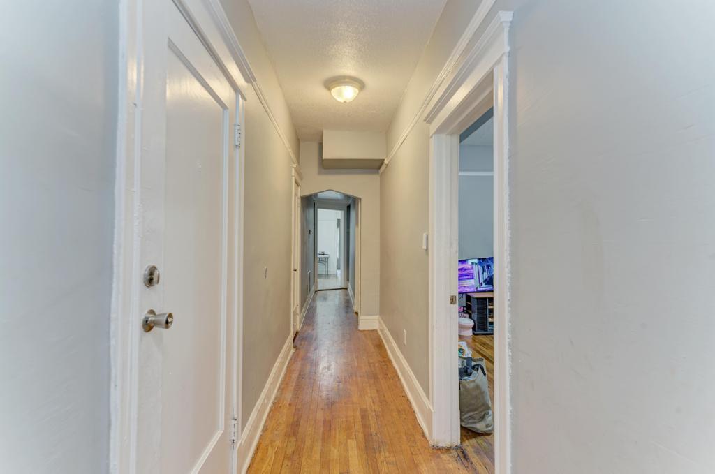 6840 South Prairie Avenue Chicago, IL 60637 - Photo 19 of 47 a view of a hallway with wooden floor and staircase
