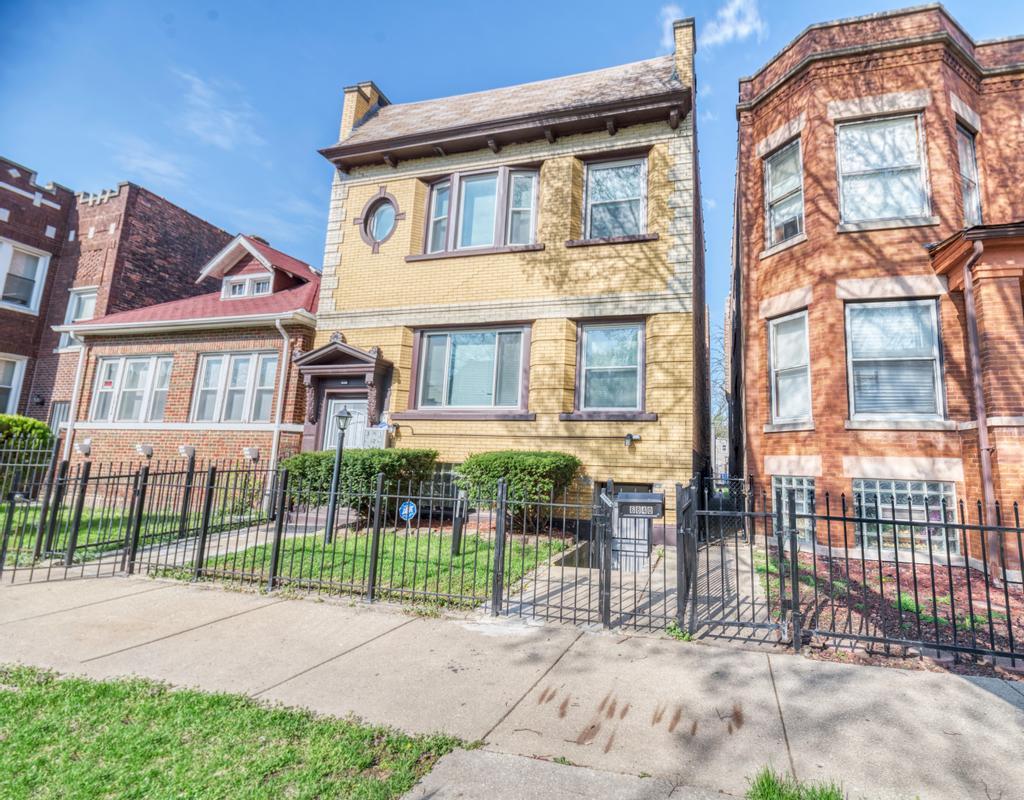 6840 South Prairie Avenue Chicago, IL 60637 - Photo 2 of 47 front view of a brick house with a small yard