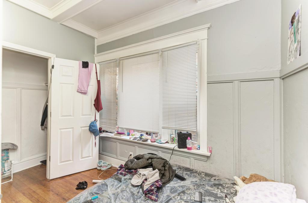 6840 South Prairie Avenue Chicago, IL 60637 - Photo 21 of 47 a very nice looking room with a white bed and a wooden floor