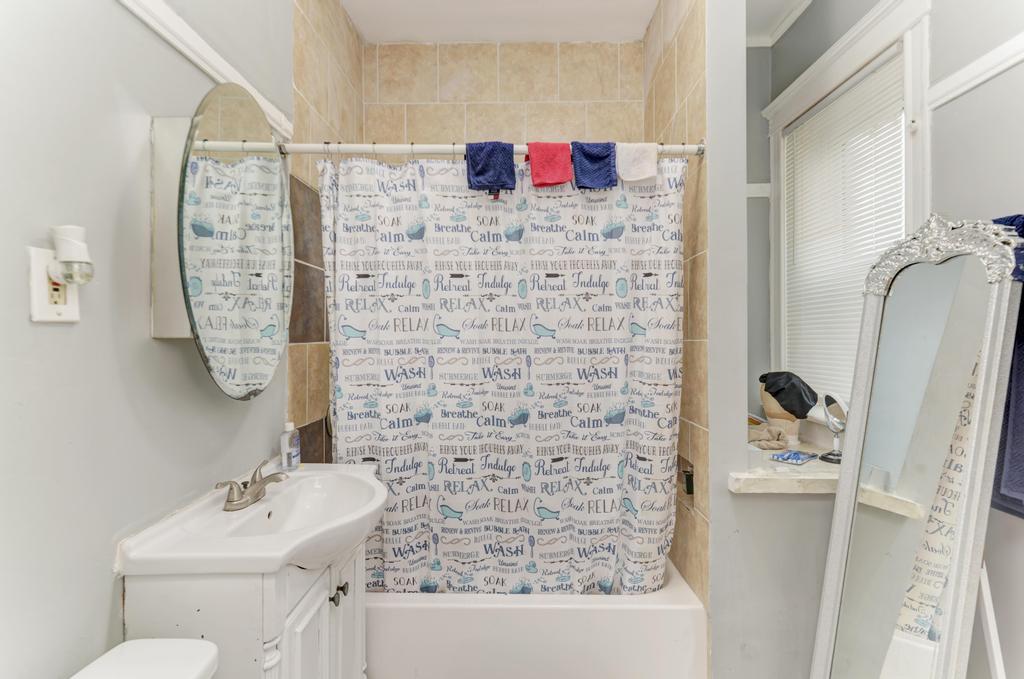 6840 South Prairie Avenue Chicago, IL 60637 - Photo 22 of 47 a bathroom with a sink mirror and shower