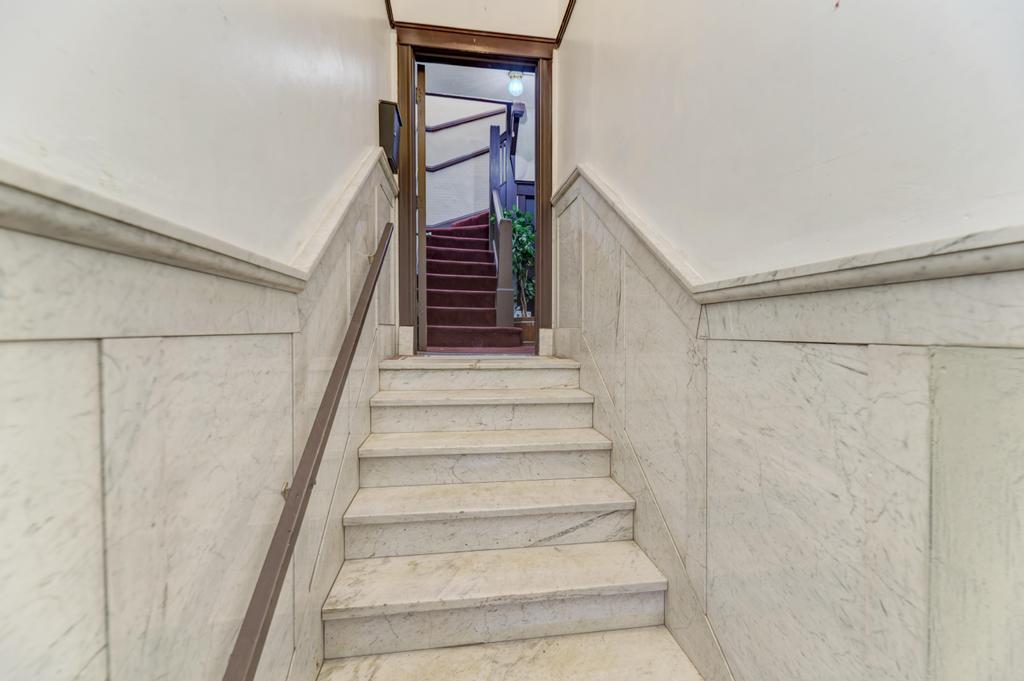 6840 South Prairie Avenue Chicago, IL 60637 - Photo 3 of 47 a view of staircase with wooden floor and white walls