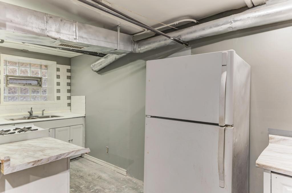 6840 South Prairie Avenue Chicago, IL 60637 - Photo 31 of 47 a kitchen with a refrigerator and a sink
