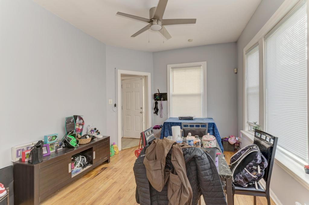 6840 South Prairie Avenue Chicago, IL 60637 - Photo 38 of 47 a bed room with a bed and a chandelier