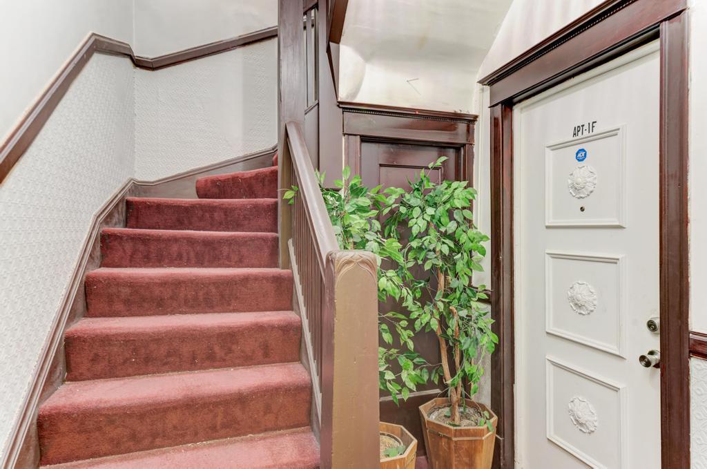 6840 South Prairie Avenue Chicago, IL 60637 - Photo 4 of 47 a view of staircase with white walls and flower plants