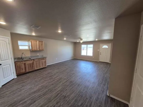 a view of a kitchen with wooden floor and a sink