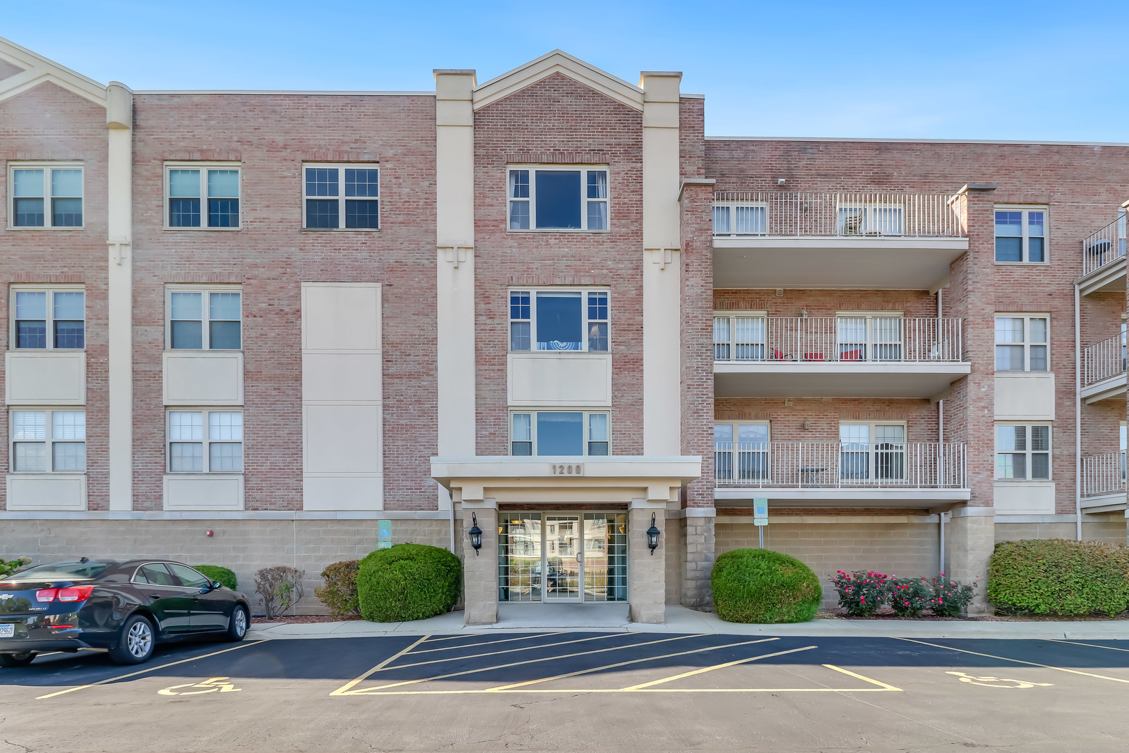 front view of a brick house with a yard