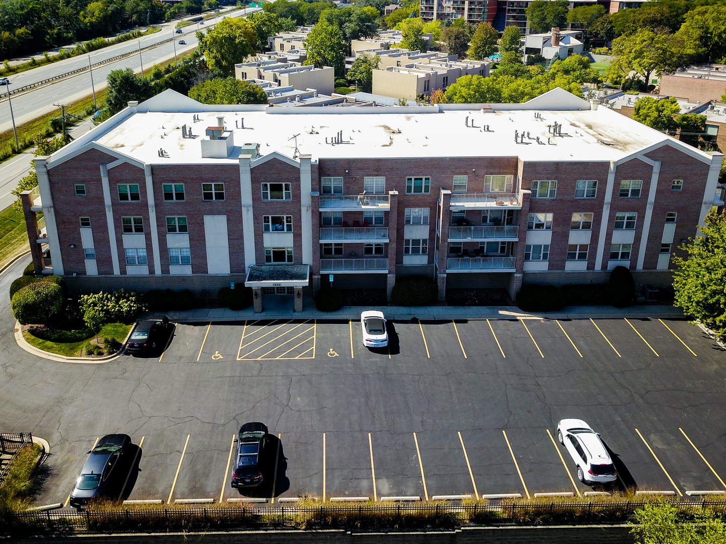 1200 South Prospect Avenue, Unit 303 Elmhurst, IL 60126 - Photo 21 of 21 a view of a back yard of the house and car parked