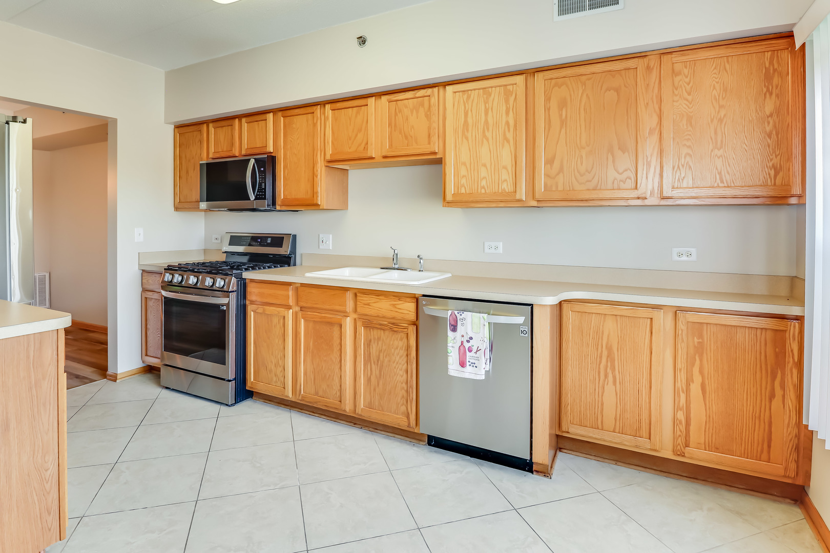 1200 South Prospect Avenue, Unit 303 Elmhurst, IL 60126 - Photo 4 of 21 a kitchen with stainless steel appliances granite countertop a stove a sink and a microwave