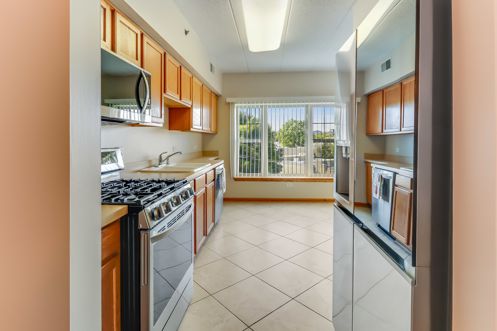 1200 South Prospect Avenue, Unit 303 Elmhurst, IL 60126 - Photo 5 of 21 a kitchen with stainless steel appliances granite countertop a stove and a refrigerator