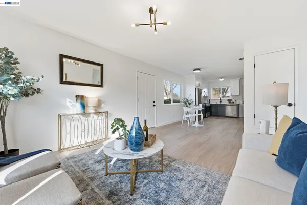 a living room with furniture and a dining table