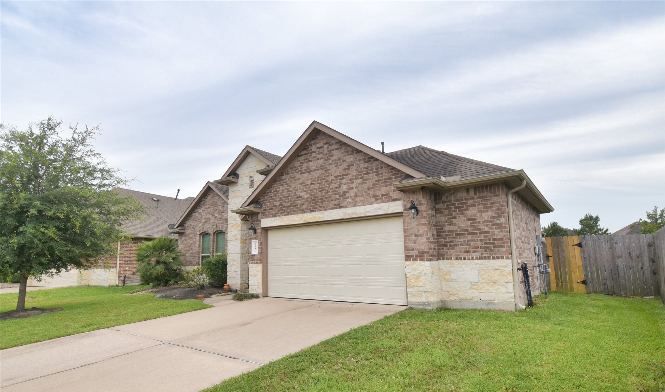 5607 South Denham Ridge Lane Spring, TX 77389 - Photo 2 of 39 a view of a house with yard and a garden