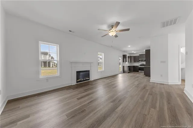 a view of kitchen and hall with wooden floor