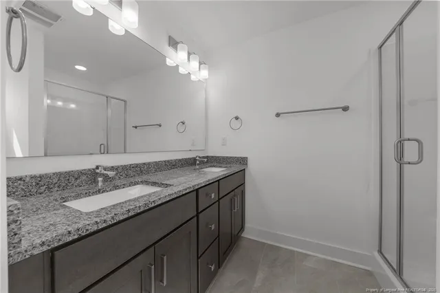 a bathroom with a glass shower door