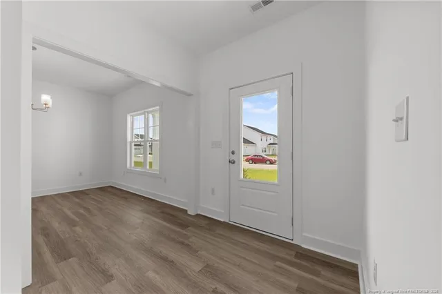 wooden floor in an empty room with a window
