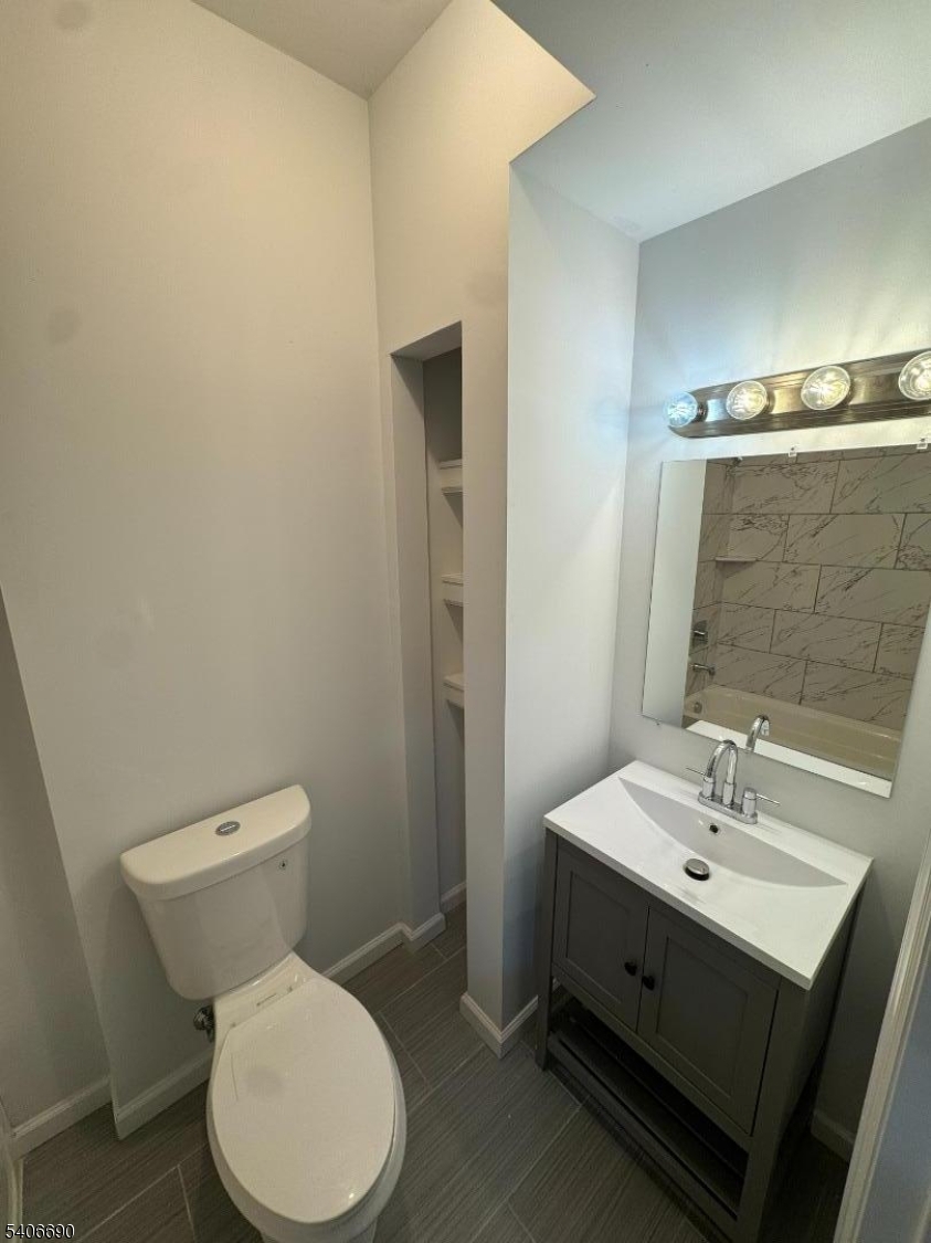 196 Malvern Street, Unit 3 Newark, NJ 07105 - Photo 9 of 16 a bathroom with a toilet sink and mirror