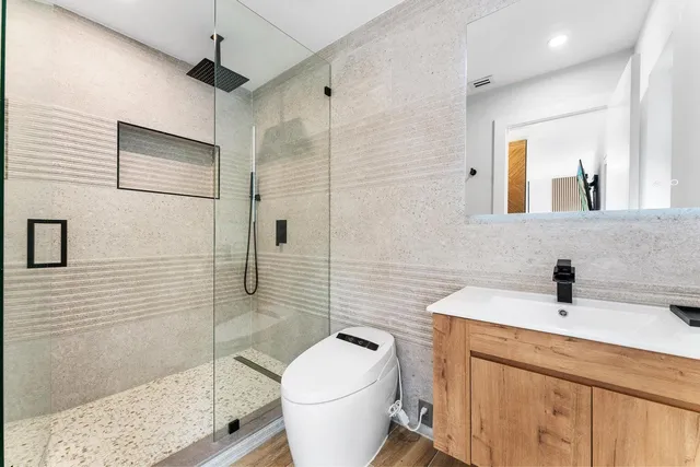 a bedroom with a bed a window and painting on the wall