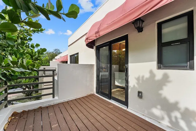 a large kitchen with granite countertop a large counter top stainless steel appliances and cabinets