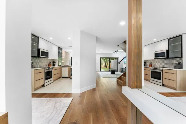 a view of a room with wooden floor and windows