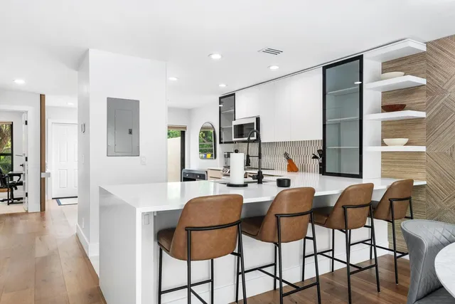 a dining room with stainless steel appliances furniture and window