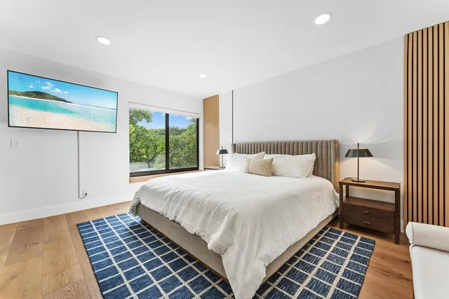 a bedroom with a large bed and a large window