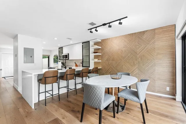 a view of kitchen with refrigerator and wooden floor