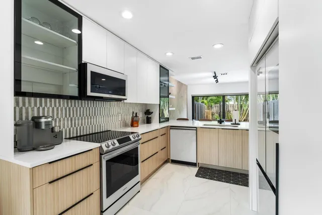a kitchen with granite countertop a sink and a stove top oven