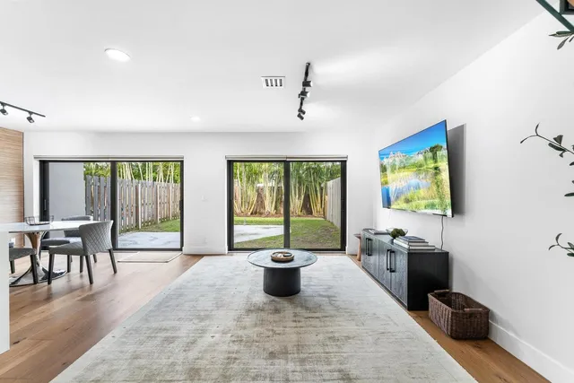 a living room with furniture and a potted plant