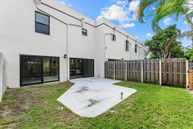 a view of a house with a door and wooden walls