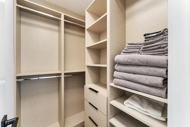 a view of a bathroom with a tub mirror and windows