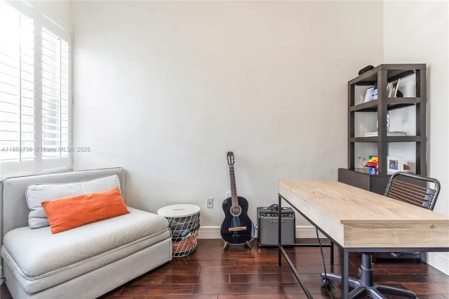 a living room with furniture a rug and a window