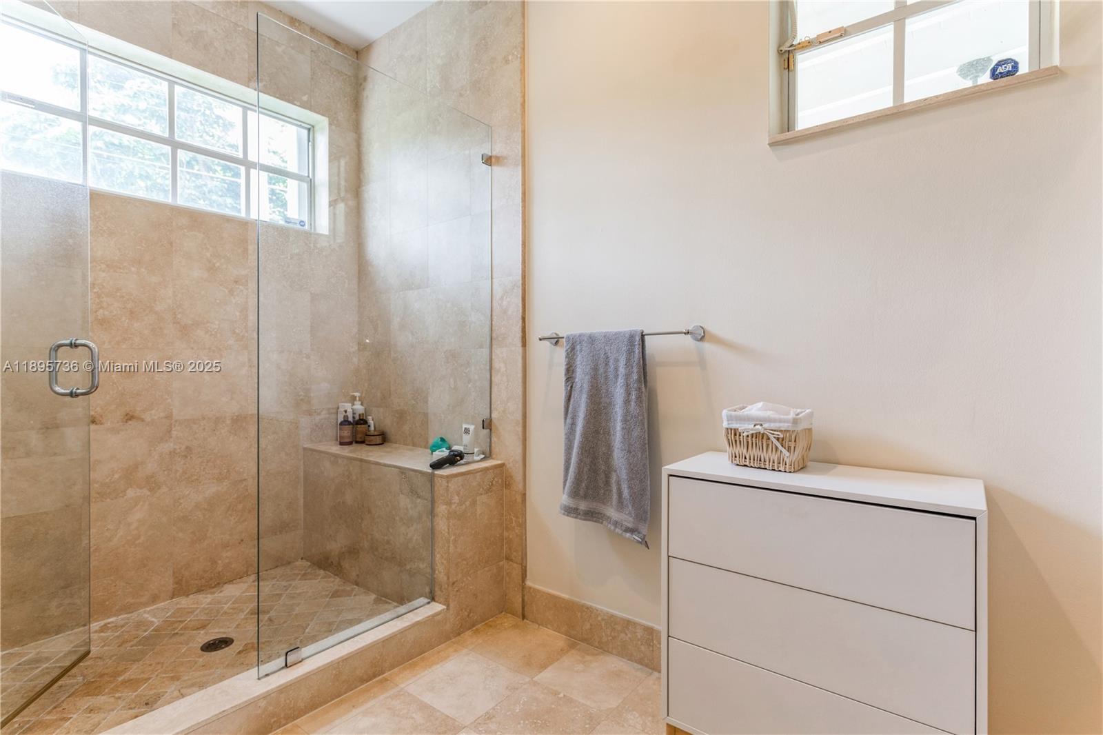 5774 Southwest 76th Terrace South Miami, FL 33143 - Photo 25 of 38 a bathroom with a shower a sink and mirror
