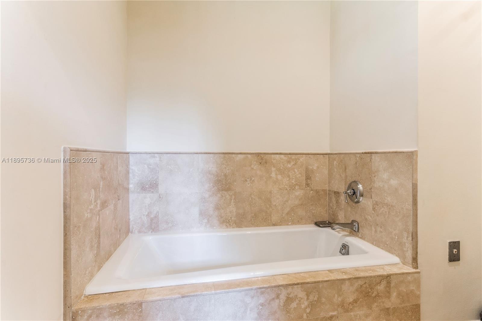 5774 Southwest 76th Terrace South Miami, FL 33143 - Photo 26 of 38 a bath tub sitting next to a white sink and vanity