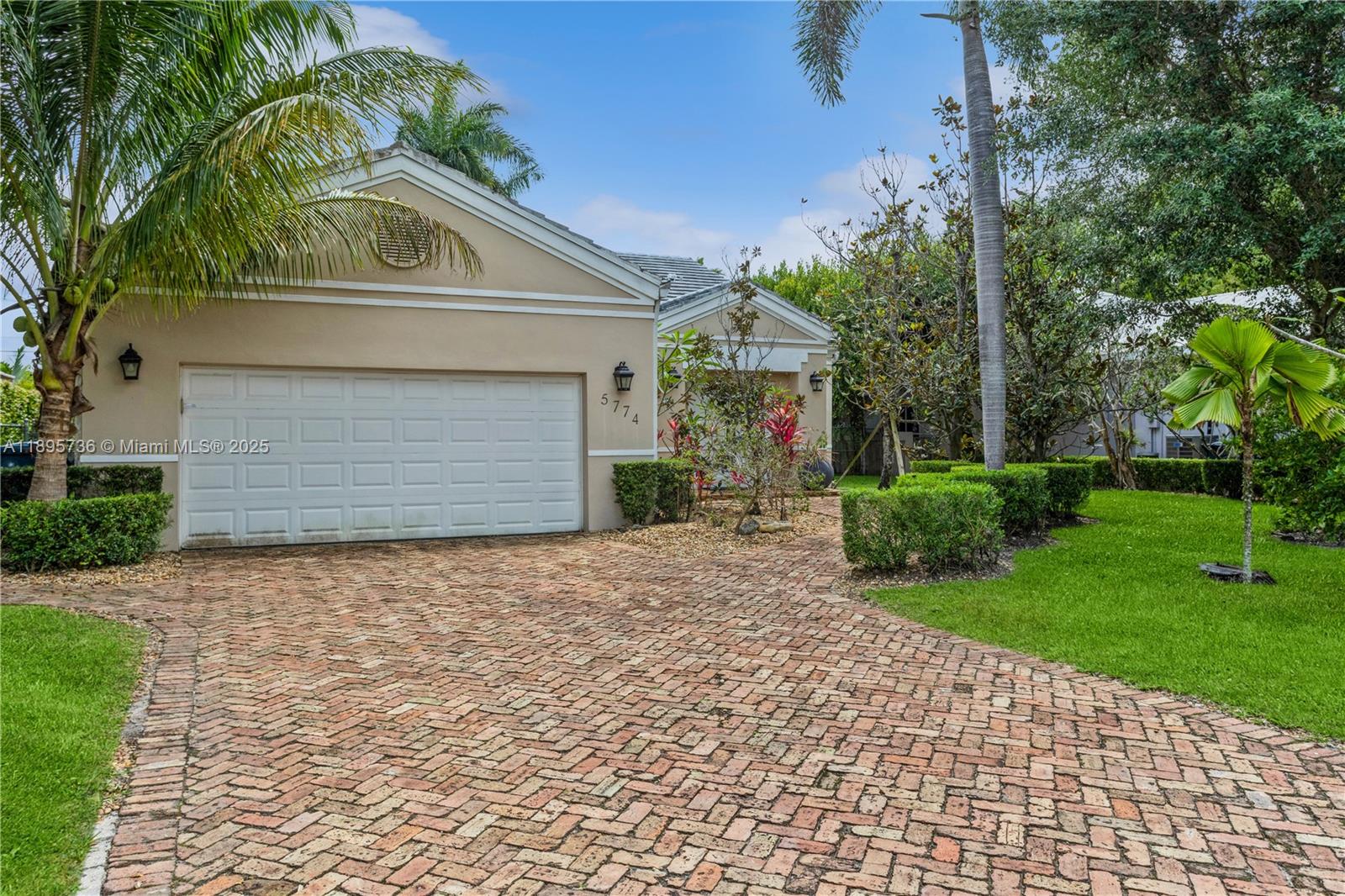 5774 Southwest 76th Terrace South Miami, FL 33143 - Photo 3 of 38 front view of house with a yard