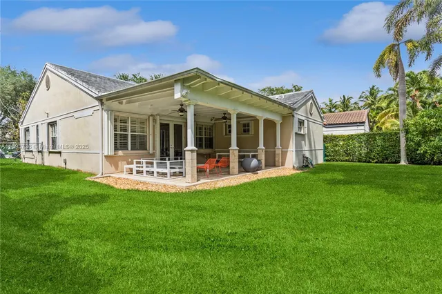 a view of a house with a small yard and sitting area