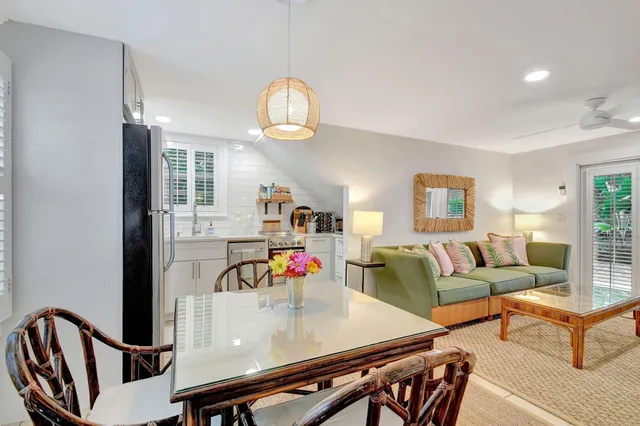 a view of a porch with a table and chairs and potted plants